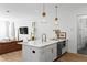 Bright kitchen island with white marble countertop, stainless steel appliances, and gold fixtures at 1429 Indiana Ave, Winter Park, FL 32789