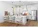 Modern kitchen with white cabinets, stainless steel appliances, and a spacious island with seating at 1429 Indiana Ave, Winter Park, FL 32789