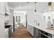 Open kitchen with hardwood floors, stainless steel appliances, and breakfast nook at 1429 Indiana Ave, Winter Park, FL 32789
