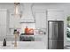 Bright kitchen features stainless steel appliances, white cabinets, and marble countertops at 1429 Indiana Ave, Winter Park, FL 32789