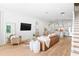 Open-concept living room featuring hardwood floors, modern furniture, and abundant natural light at 1429 Indiana Ave, Winter Park, FL 32789