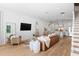 Spacious living room featuring hardwood floors, modern furnishings, and an open layout connected to the kitchen at 1429 Indiana Ave, Winter Park, FL 32789