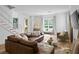 Comfortable living room features a large sectional sofa, stylish decor, and natural light from the large windows at 1429 Indiana Ave, Winter Park, FL 32789