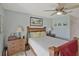 Charming bedroom featuring a wooden bed frame, ceiling fan and neutral color scheme at 149 Acadia Dr, Kissimmee, FL 34759