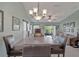 Bright dining room showcasing neutral paint, lots of seating, and an adjacent living room at 149 Acadia Dr, Kissimmee, FL 34759