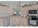 Kitchen featuring stainless steel appliances, neutral countertops, and a breakfast bar with views into the living room at 149 Acadia Dr, Kissimmee, FL 34759