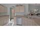 Kitchen featuring stainless steel appliances, neutral countertops, and a view into the living room at 149 Acadia Dr, Kissimmee, FL 34759