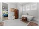 Spa-like bathroom featuring a freestanding tub, neutral decor, and a serene ambiance at 1590 Harston Ave, Orlando, FL 32814