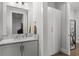 Bathroom featuring a marble vanity with storage, grey cabinets, and a modern faucet at 1590 Harston Ave, Orlando, FL 32814