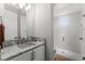 Bright bathroom featuring a marble countertop and modern glass enclosed shower with white subway tiles at 1590 Harston Ave, Orlando, FL 32814