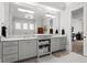 Bathroom with double vanity, white cabinets and marble countertops at 1590 Harston Ave, Orlando, FL 32814