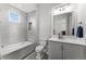Serene bathroom with a tub, shower, a large mirror, and modern fixtures at 1590 Harston Ave, Orlando, FL 32814