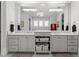 Bathroom with double vanity, white cabinets and marble countertops at 1590 Harston Ave, Orlando, FL 32814