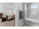 Spacious bathroom featuring a shower/tub combo with gray tiled walls and a built-in ledge at 1590 Harston Ave, Orlando, FL 32814