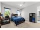 Inviting bedroom with a desk, large windows, carpet flooring, and a ceiling fan at 1590 Harston Ave, Orlando, FL 32814