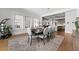 Elegant dining room with hardwood floors, stylish rug, and ample natural light with easy access to the kitchen at 1590 Harston Ave, Orlando, FL 32814