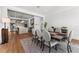 Elegant dining room with seating for eight, hardwood floors, and open to kitchen at 1590 Harston Ave, Orlando, FL 32814