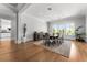 Well-lit dining room features seating for eight, hardwood floors and a view to the outside at 1590 Harston Ave, Orlando, FL 32814