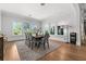 Bright dining room with hardwood floors, large windows, and a table with seating for eight at 1590 Harston Ave, Orlando, FL 32814