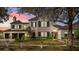Elegant two-story home featuring manicured landscaping and a charming facade at twilight at 1590 Harston Ave, Orlando, FL 32814