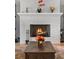 Close up of a cozy fireplace with decorative accents on the mantle and a warm ambiance at 1590 Harston Ave, Orlando, FL 32814