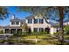 Stunning two-story home with manicured lawn and sophisticated architectural details, offering timeless curb appeal at 1590 Harston Ave, Orlando, FL 32814