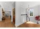 Bright hallway features hardwood floors and stylish decor with access to a naturally lit staircase at 1590 Harston Ave, Orlando, FL 32814