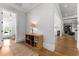 Brightly lit hallway features hardwood floors and provides entry to nearby rooms at 1590 Harston Ave, Orlando, FL 32814