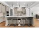Modern kitchen with large island, pendant lighting, breakfast bar and stainless steel appliances at 1590 Harston Ave, Orlando, FL 32814