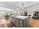 Open kitchen with a center island, stainless steel appliances, and views to the dining and living rooms at 1590 Harston Ave, Orlando, FL 32814
