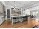 Modern kitchen featuring a large center island with seating, pendant lighting, and views into the dining room at 1590 Harston Ave, Orlando, FL 32814