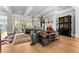 Open-concept living area with fireplace, hardwood floors, and view of the outdoor living space at 1590 Harston Ave, Orlando, FL 32814