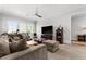 Comfortable living room area with a large sectional sofa and ceiling fan at 1590 Harston Ave, Orlando, FL 32814