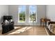 Bright living room features hardwood floors, arched windows, telescope, and plenty of natural light at 1590 Harston Ave, Orlando, FL 32814