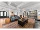 Open-concept living room featuring hardwood floors, coffered ceilings, and a view into the modern kitchen at 1590 Harston Ave, Orlando, FL 32814