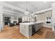 Open-concept living space with kitchen island, stainless steel appliances and hardwood floors at 1590 Harston Ave, Orlando, FL 32814