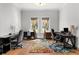 Bright office space with hardwood floors, dual desks and a colorful area rug at 1590 Harston Ave, Orlando, FL 32814