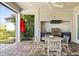 Inviting outdoor kitchen with a built-in grill, countertop, and a dining table on a covered patio at 1590 Harston Ave, Orlando, FL 32814