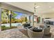 Relax on the outdoor patio with comfortable seating and a view of the pool and backyard at 1590 Harston Ave, Orlando, FL 32814