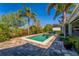Beautiful swimming pool surrounded by tropical landscaping, offering a private backyard oasis at 1590 Harston Ave, Orlando, FL 32814