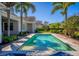 A sparkling swimming pool sits in a backyard surrounded by lush tropical plants at 1590 Harston Ave, Orlando, FL 32814