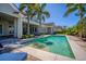 Gorgeous in-ground pool with palm trees and comfortable lounge seating, perfect for outdoor living and entertainment at 1590 Harston Ave, Orlando, FL 32814