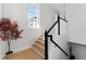 Beautiful staircase features wood treads, black handrail, and plenty of natural light from the large window at 1590 Harston Ave, Orlando, FL 32814