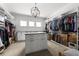 Bright walk-in closet with natural light, central dresser, and ample custom shelving at 1590 Harston Ave, Orlando, FL 32814
