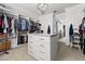 Spacious walk-in closet with custom shelving, central dresser, and modern lighting at 1590 Harston Ave, Orlando, FL 32814