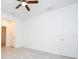 Bright and airy bedroom featuring a ceiling fan, neutral walls, and convenient closet and bathroom access at 15998 Sw 33Rd Avenue Rd, Ocala, FL 34473