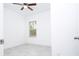 Bright bedroom featuring tile flooring, a ceiling fan, and a window at 15998 Sw 33Rd Avenue Rd, Ocala, FL 34473