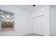 Bright bedroom featuring tile flooring, a closet, and a window at 15998 Sw 33Rd Avenue Rd, Ocala, FL 34473