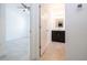 View from hallway into bedroom and bathroom with double sink vanity at 15998 Sw 33Rd Avenue Rd, Ocala, FL 34473