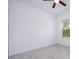 Bright bedroom features tile flooring, a ceiling fan, and a window with natural light at 15998 Sw 33Rd Avenue Rd, Ocala, FL 34473